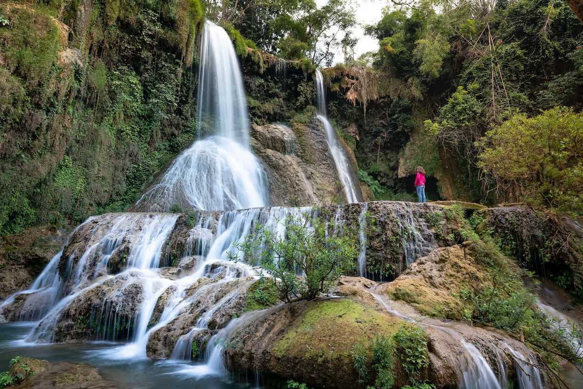 A series of waterfalls flowing down a rocky slope.